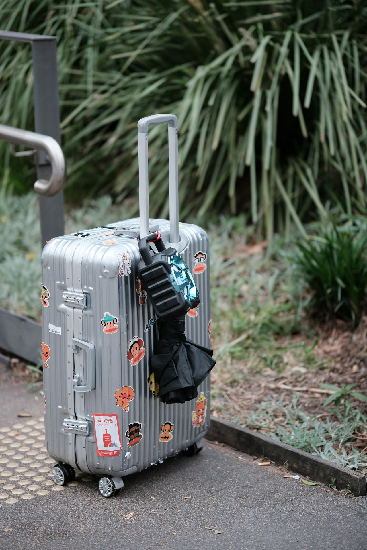 A piece of luggage sitting on top of a sidewalk